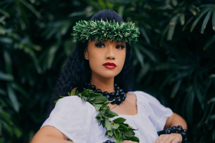 a person wearing a white shirt and green bushes