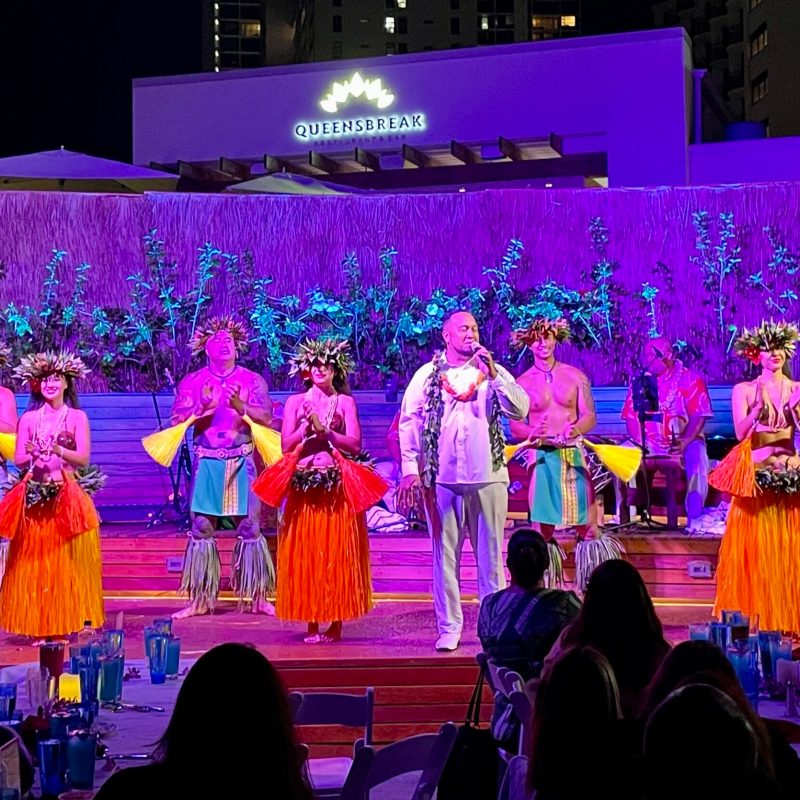 a group of people on a stage in front of a crowd