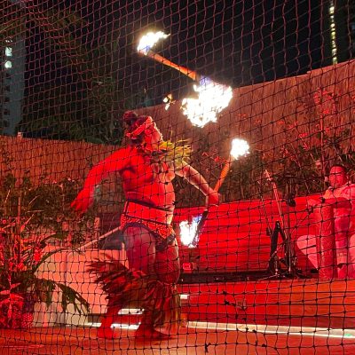 a band performing on stage in front of a fence