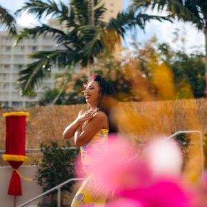 a person standing in front of a flower