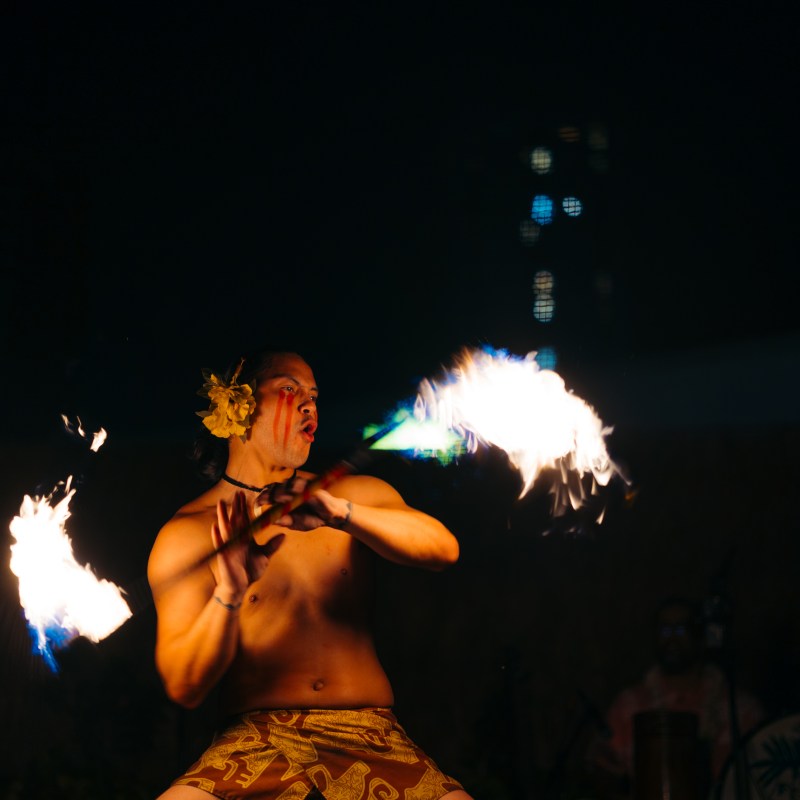 a man standing in front of a fire